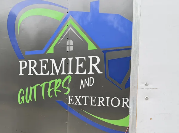 The Premier Gutters and Exterior logo on the side of the company trailer