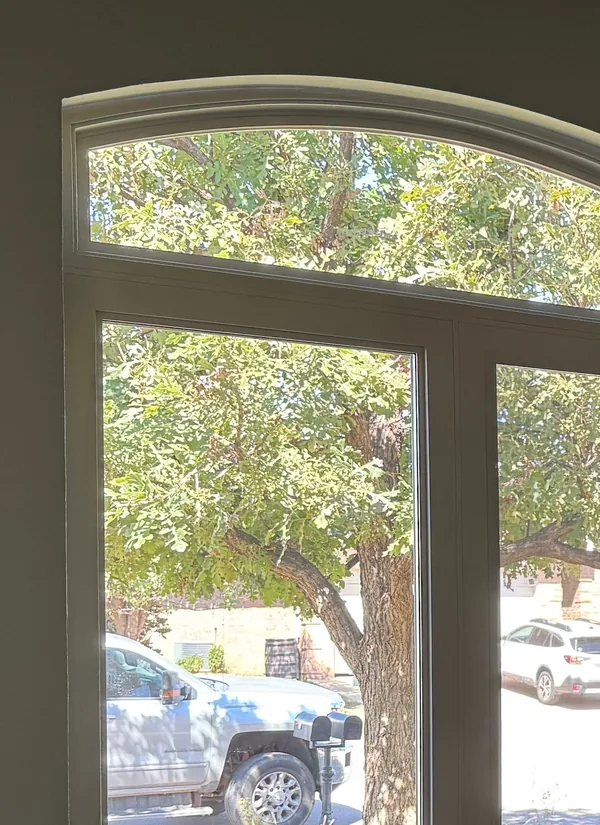 A tall arched window seen from inside a room